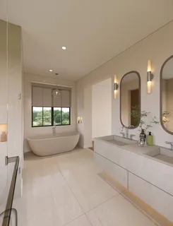 a spacious bathroom with a double vanity sink and mirror with bathtub
