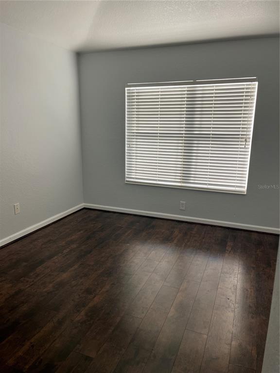 4971 Southwest 45th Street Ocala, FL 34474 - Photo 14 of 14 a view of an empty room with wooden floor and a window