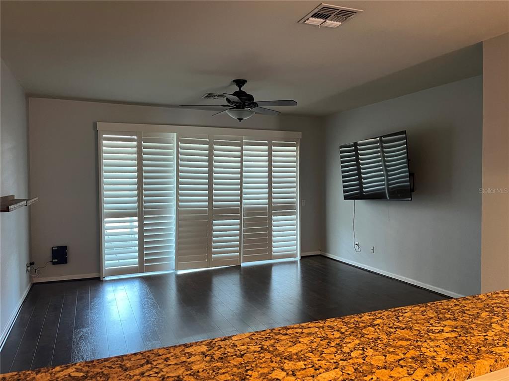 4971 Southwest 45th Street Ocala, FL 34474 - Photo 5 of 14 wooden floor in an empty room with a window