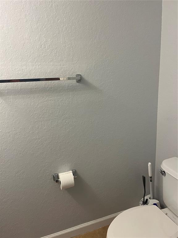 4971 Southwest 45th Street Ocala, FL 34474 - Photo 7 of 14 a bathroom with a toilet and a shower