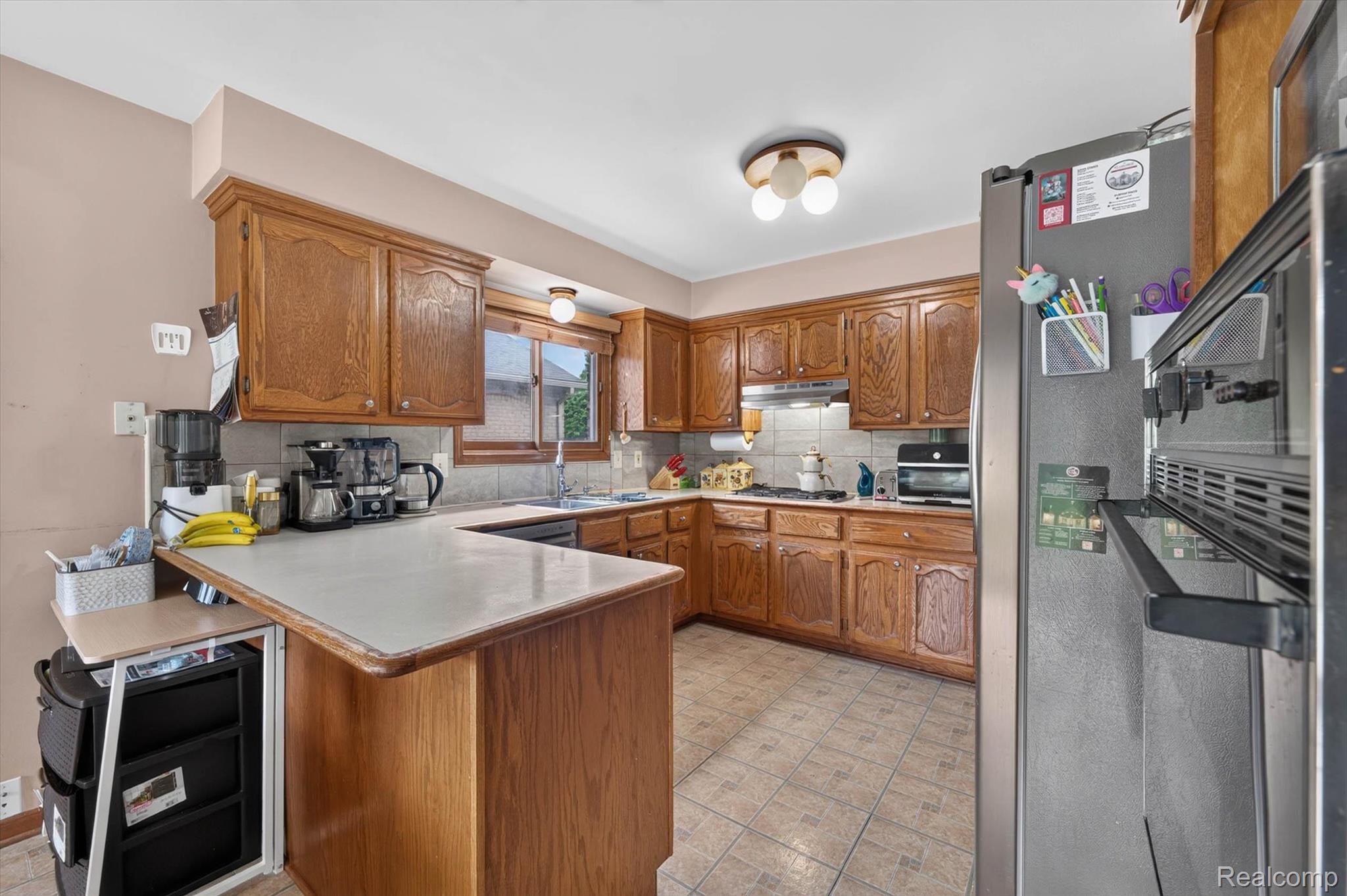 46362 Springhill Drive Utica, MI 48317 - Photo 13 of 59 Kitchen featuring wood cabinetry, light countertops, and tile flooring