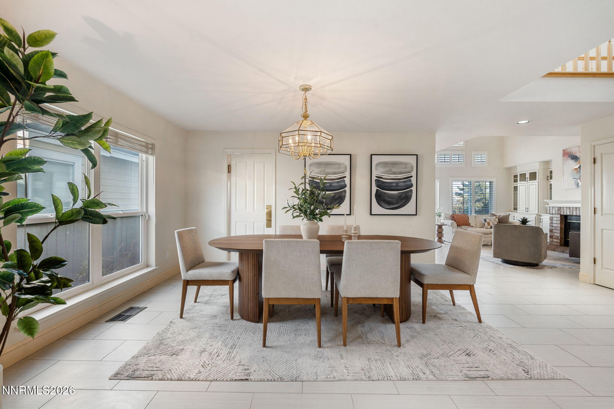 6186 Squires Lane Reno, NV 89519 - Photo 8 of 57 a dining room with furniture a rug and a chandelier