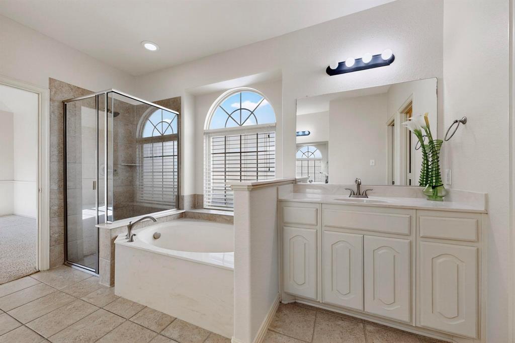 9329 Turtle Pass Fort Worth, TX 76177 - Photo 20 of 31 a spacious en suite bathroom with a granite countertop tub a double vanity sink a window and a mirror