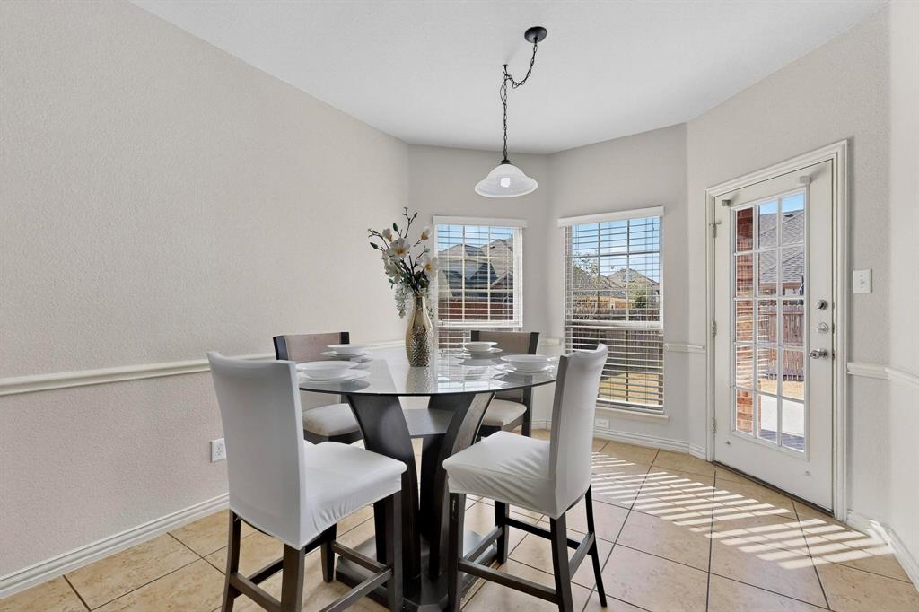 9329 Turtle Pass Fort Worth, TX 76177 - Photo 3 of 31 a view of a dining room with furniture window and wooden floor