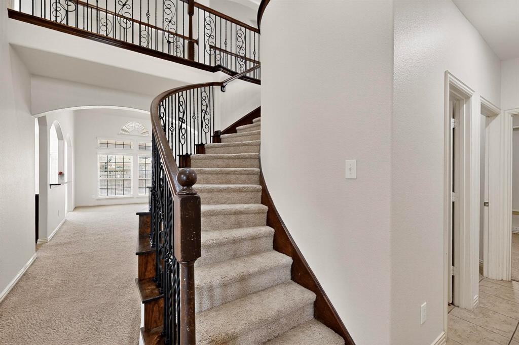 9329 Turtle Pass Fort Worth, TX 76177 - Photo 5 of 31 a view of staircase with wooden floor and white walls