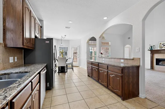 a kitchen with stainless steel appliances granite countertop a sink counter space and cabinets
