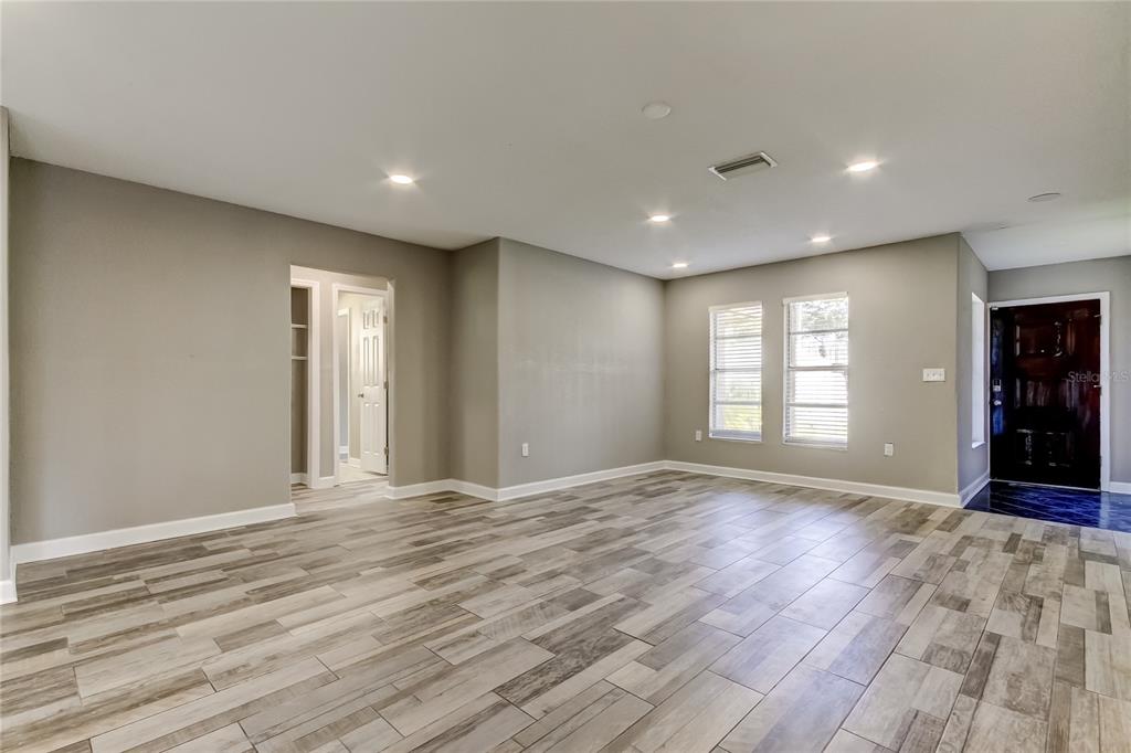 8330 Lafitte Drive Hudson, FL 34667 - Photo 16 of 34 a view of an empty room with wooden floor and a window