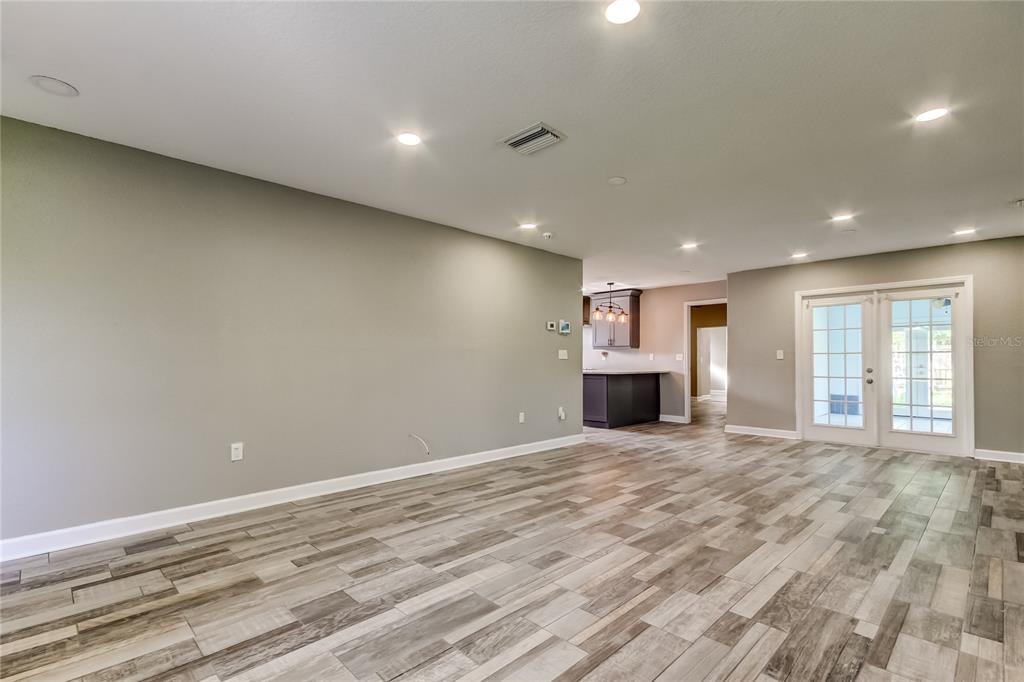 8330 Lafitte Drive Hudson, FL 34667 - Photo 17 of 34 a view of an empty room with a fireplace and a window