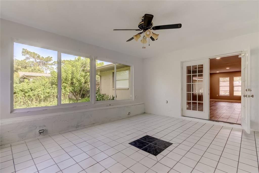 8330 Lafitte Drive Hudson, FL 34667 - Photo 21 of 34 a view of an empty room with a window and a ceiling fan