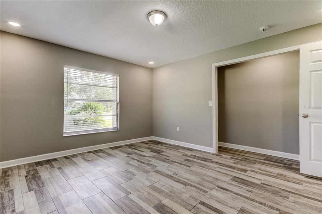 8330 Lafitte Drive Hudson, FL 34667 - Photo 24 of 34 an empty room with wooden floor and windows