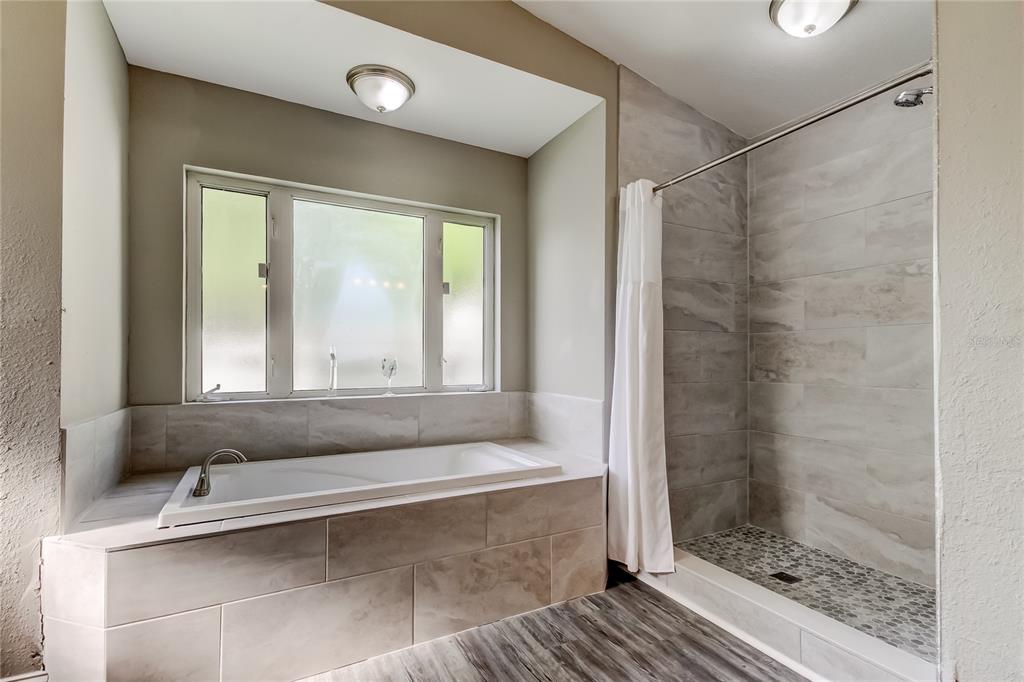 8330 Lafitte Drive Hudson, FL 34667 - Photo 6 of 34 a bathroom with a bathtub and a shower