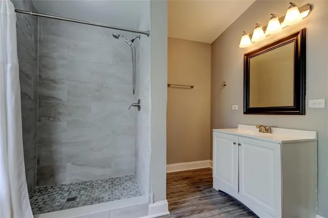a bathroom with a shower sink and mirror