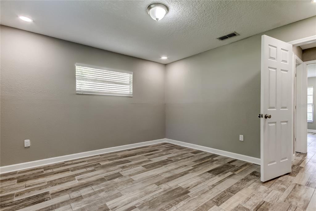 8330 Lafitte Drive Hudson, FL 34667 - Photo 10 of 34 a view of a room with a wooden floor and window