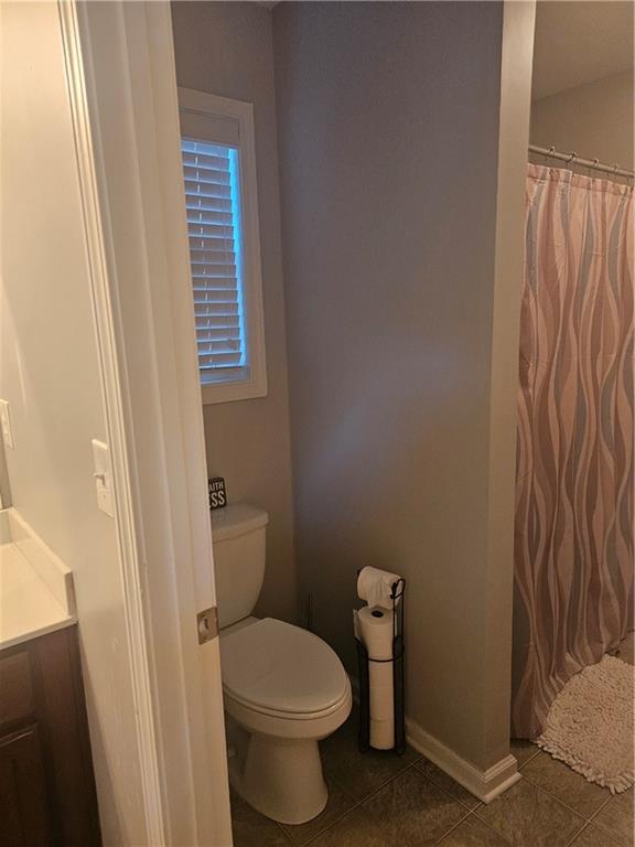 5639 Chatham Circle Northwest Norcross, GA 30071 - Photo 11 of 16 a white toilet sitting next to a shower curtain