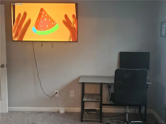 a room with a chair and a painting on the wall