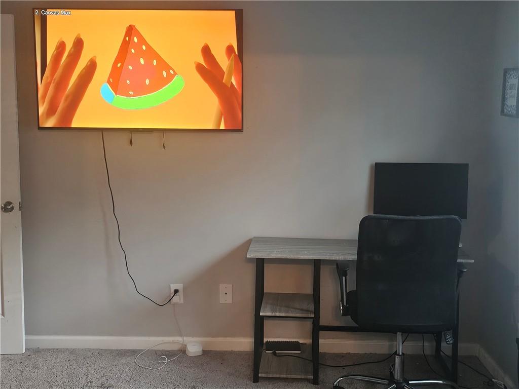 5639 Chatham Circle Northwest Norcross, GA 30071 - Photo 13 of 16 a room with a chair and a painting on the wall