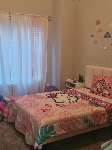 a bedroom with a bed and a curtain