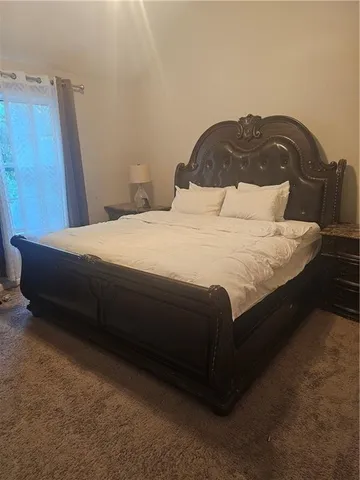 a bedroom with a bed and a mirror