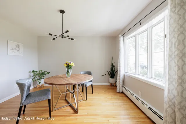 a view of a dining room with furniture window and wooden floor