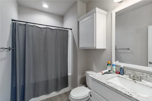 a bedroom with a bed and a bookshelf