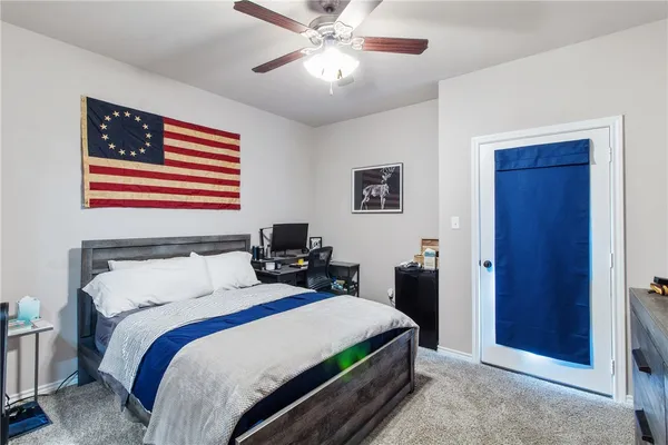 a bedroom with furniture and a flat screen tv