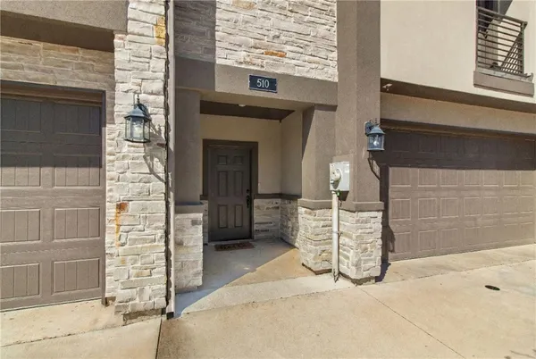 a living room with stainless steel appliances kitchen island furniture and a flat screen tv