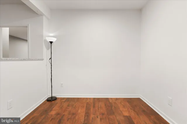 a view of a room with wooden floor