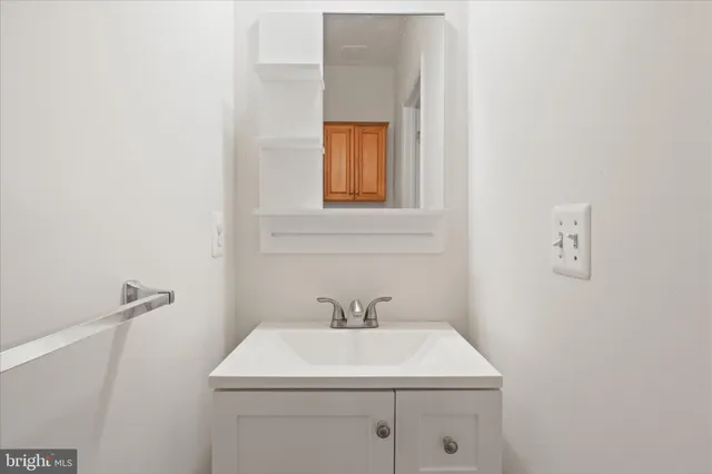 a bathroom with a sink a mirror and vanity