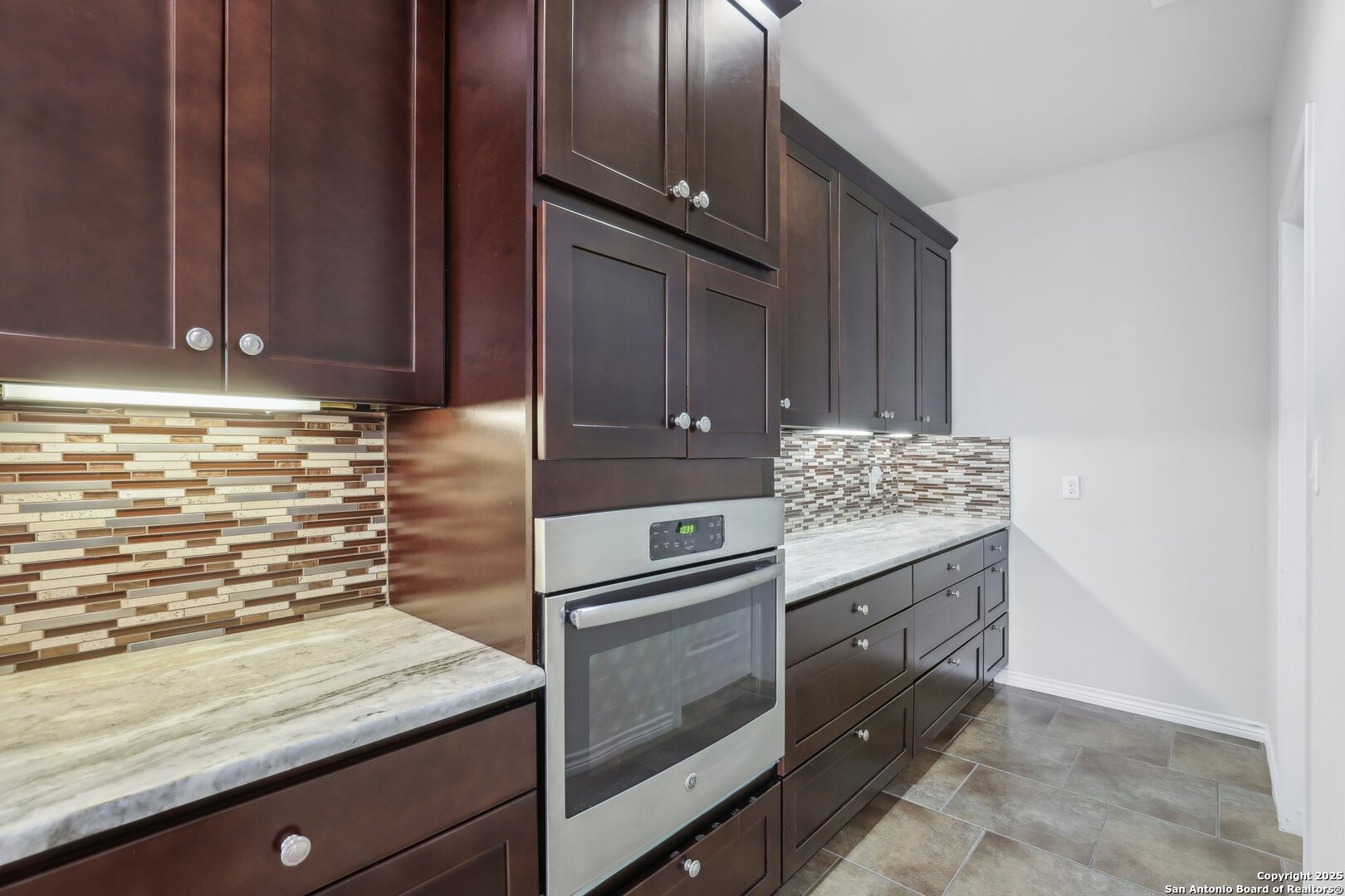 138 Gable Street Kyle, TX 78640 - Photo 13 of 51 a kitchen with granite countertop cabinets stainless steel appliances and a counter space