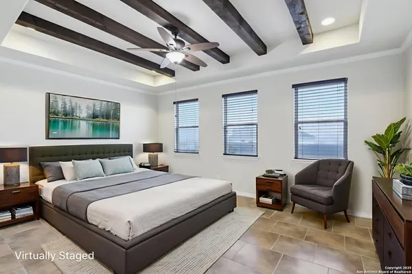 a bedroom with a bed couch and windows