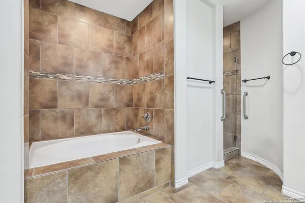a bathroom with a bathtub and shower