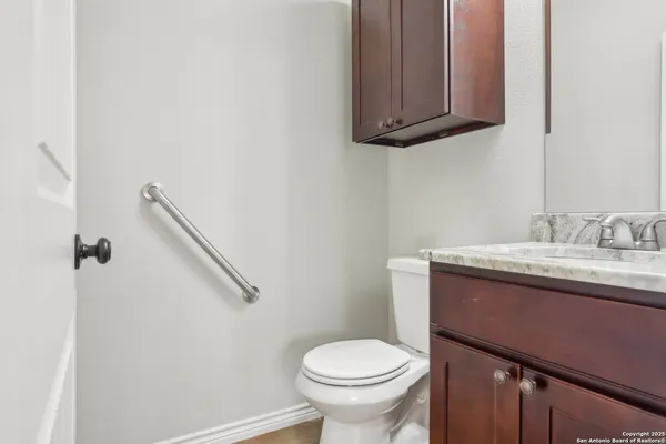 a bathroom with a sink toilet and vanity