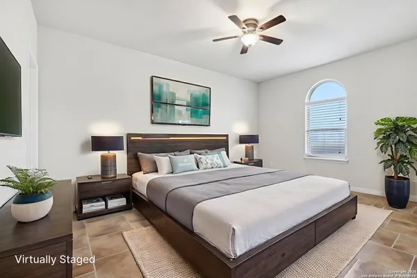 a bedroom with bed and a potted plant