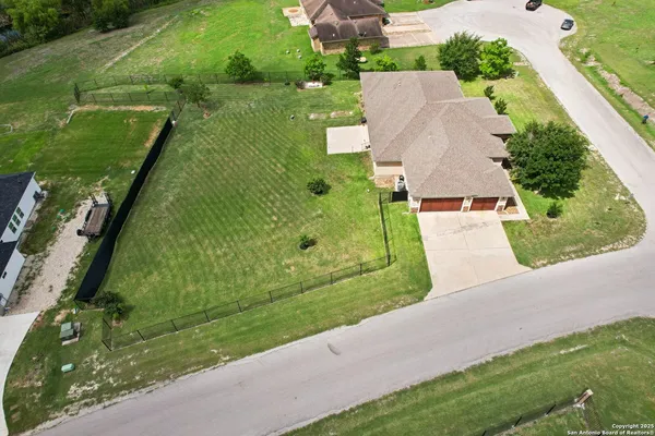 an aerial view of residential houses with outdoor space