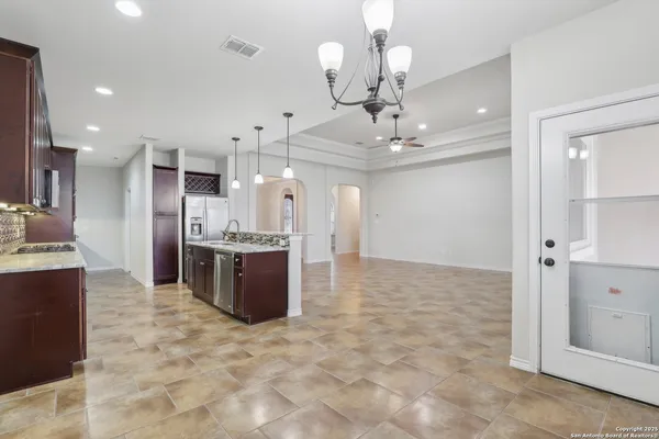 a large kitchen with stainless steel appliances kitchen island granite countertop a large counter top and cabinets