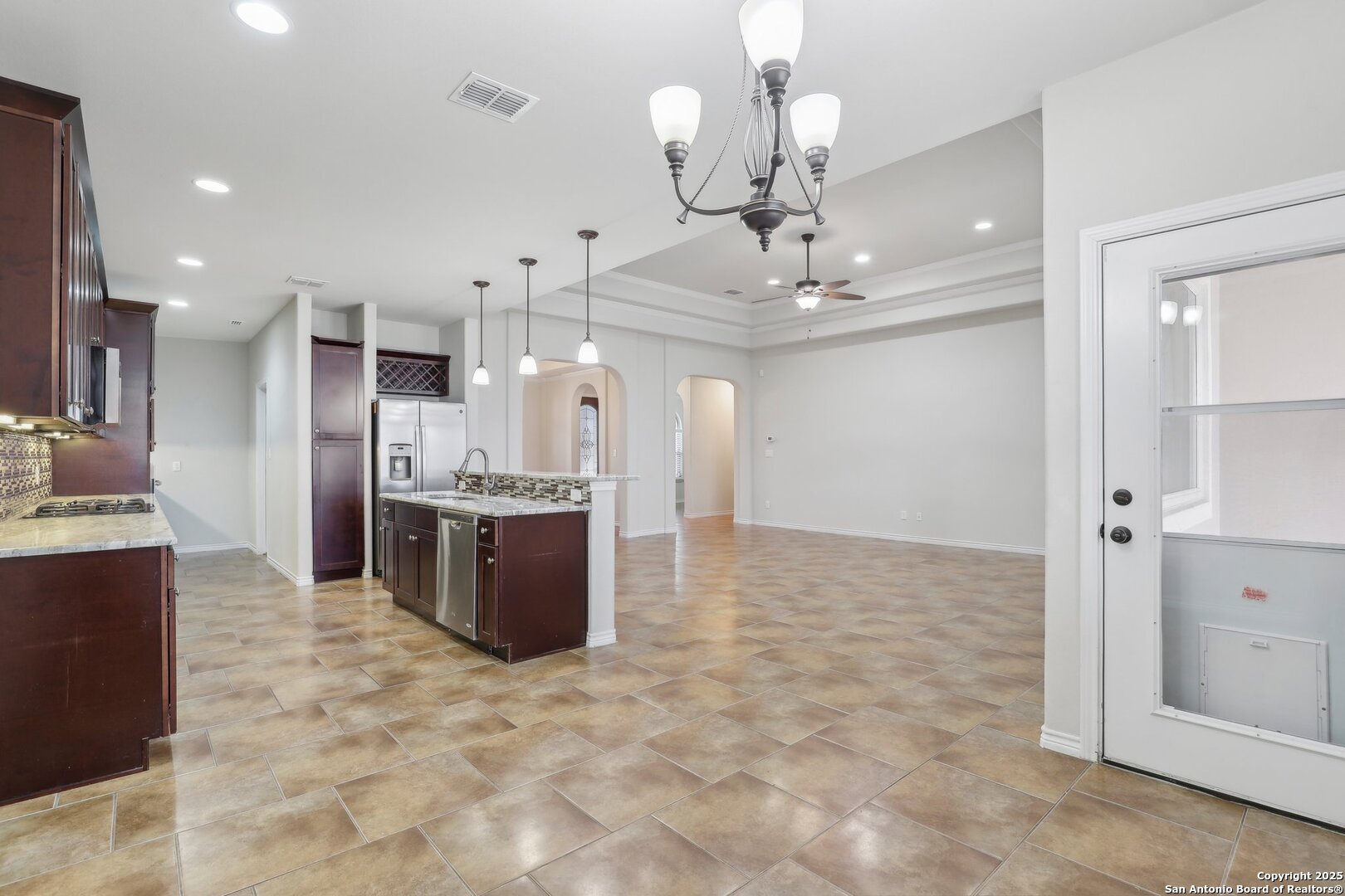 138 Gable Street Kyle, TX 78640 - Photo 6 of 51 a large kitchen with stainless steel appliances kitchen island granite countertop a large counter top and cabinets