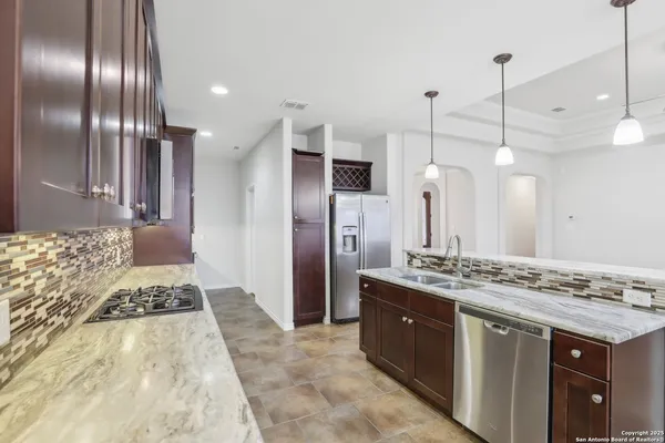 a bathroom with a granite countertop sink a large mirror and shower