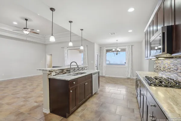 a kitchen with stainless steel appliances granite countertop a stove and a sink