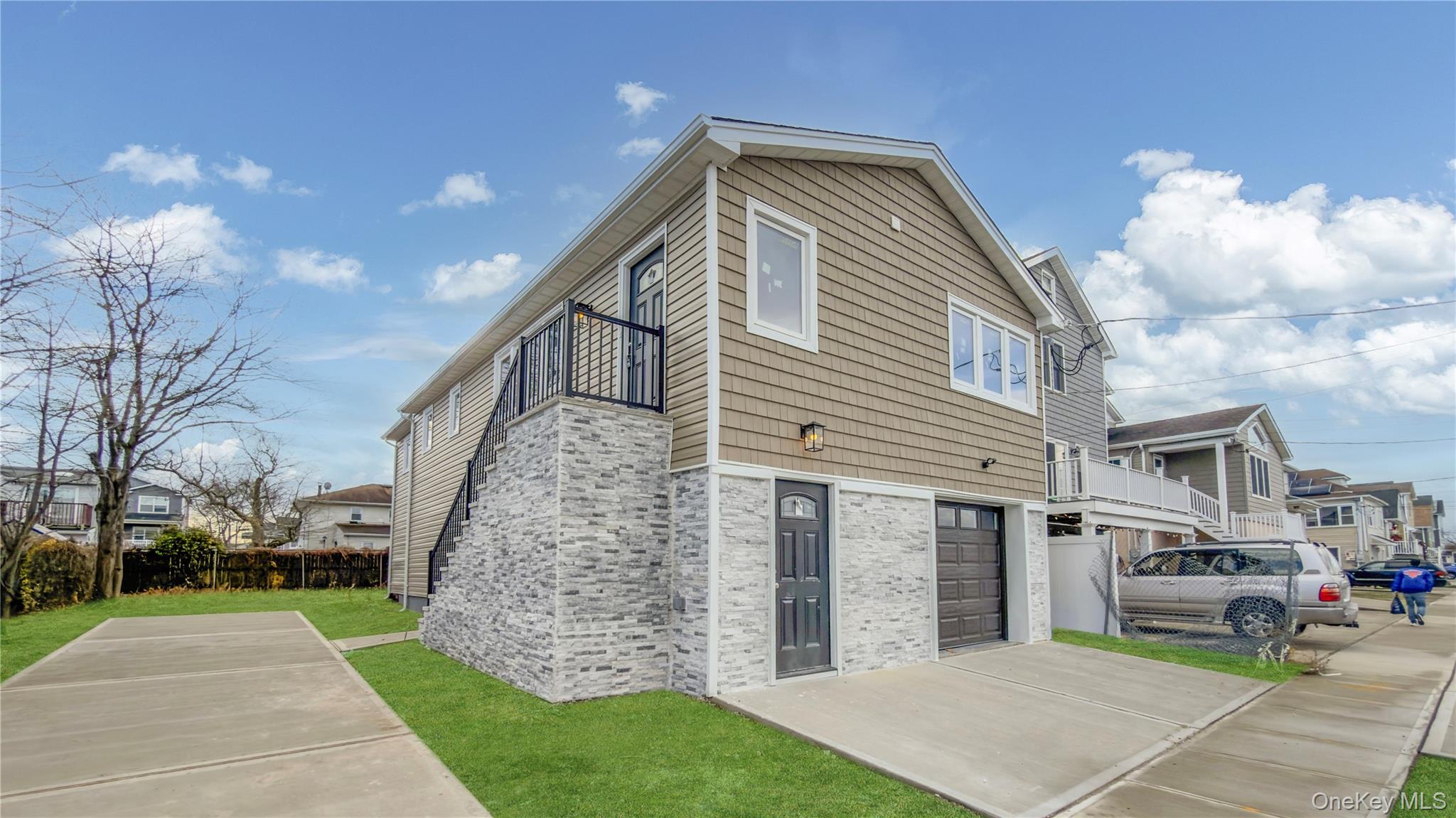 37 Deal Road Island Park, NY 11558 - Photo 1 of 50 View of home's exterior featuring brick siding and a balcony