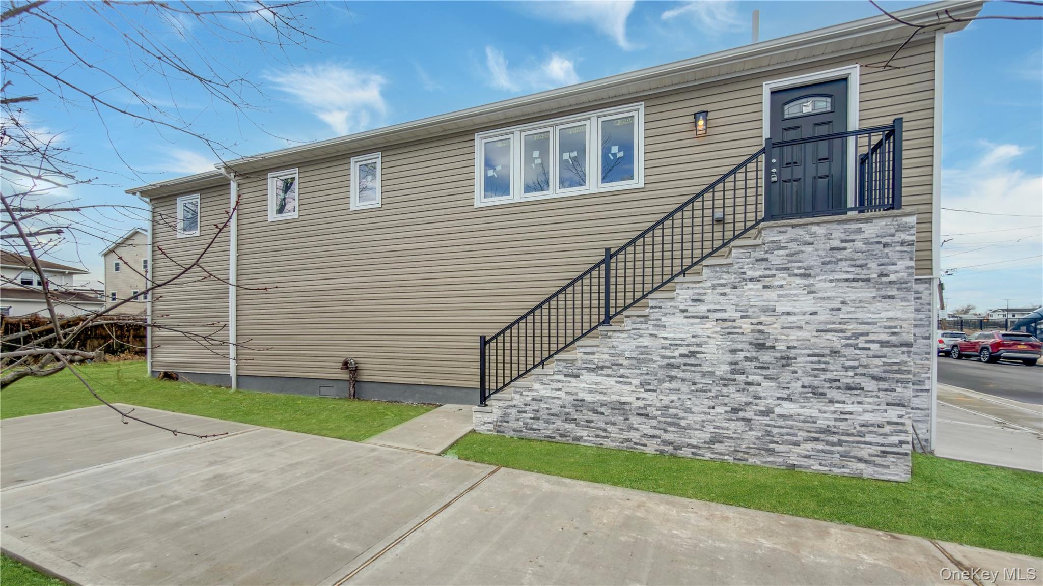 37 Deal Road Island Park, NY 11558 - Photo 11 of 50 View of front of property featuring stairway and a front lawn