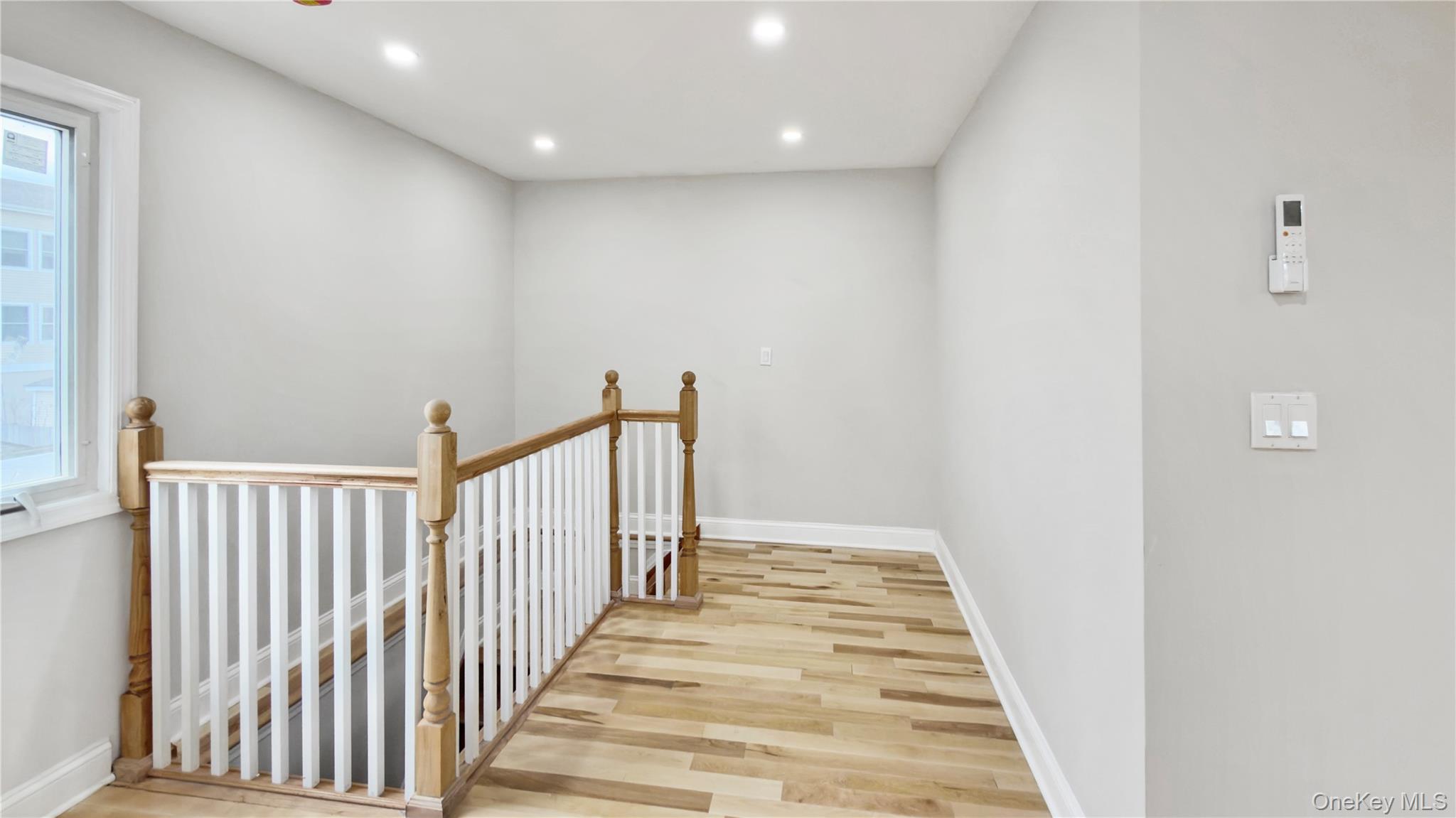 37 Deal Road Island Park, NY 11558 - Photo 18 of 50 Hallway featuring an upstairs landing, recessed lighting, and light wood-style flooring
