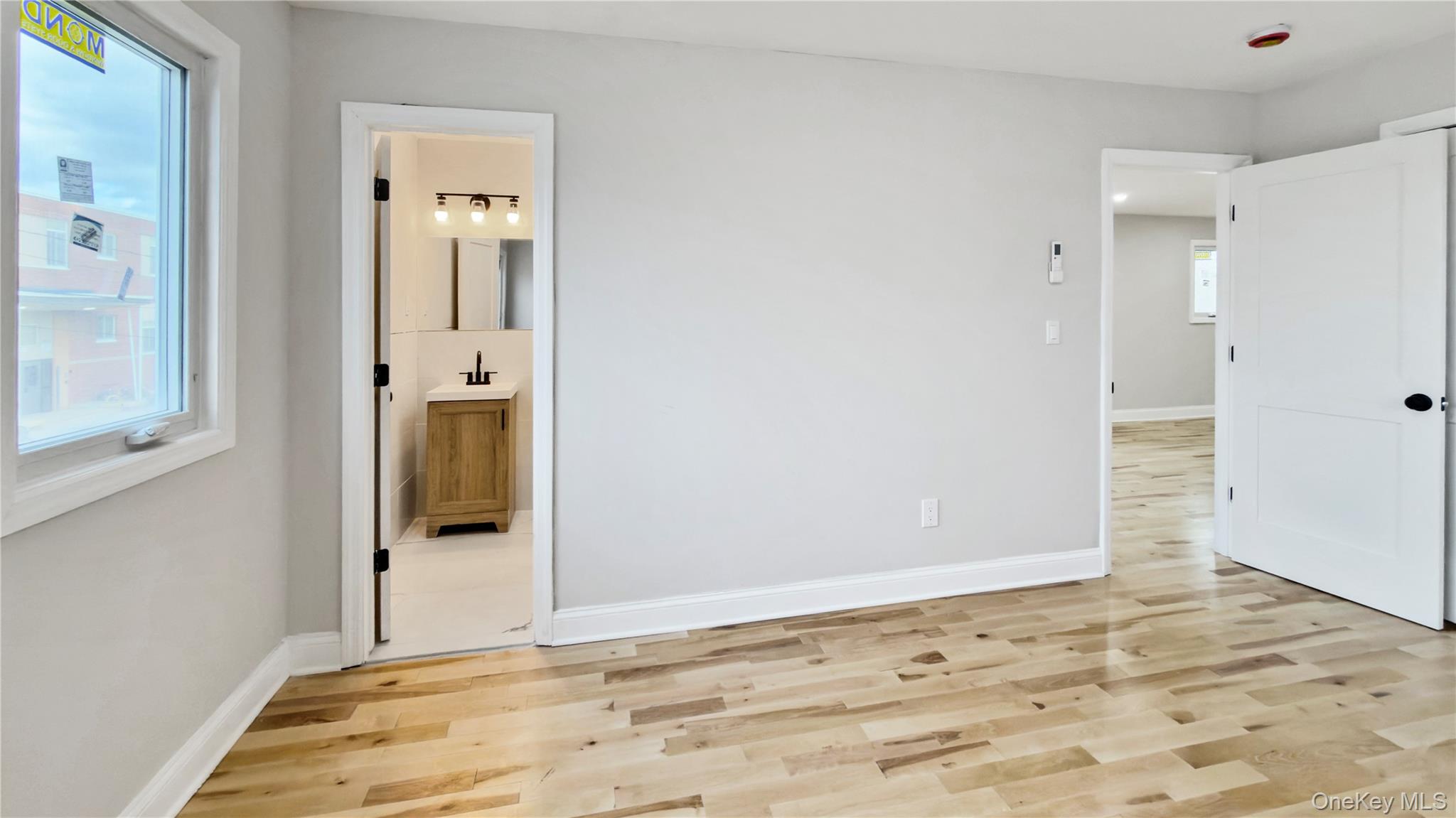 37 Deal Road Island Park, NY 11558 - Photo 28 of 50 Unfurnished bedroom featuring light wood finished floors and ensuite bathroom