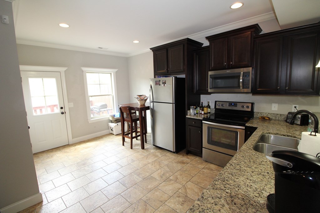 1348 Weeks Drive Northeast Cleveland, TN 37312 - Photo 8 of 25 a kitchen with granite countertop a refrigerator stove top oven and sink