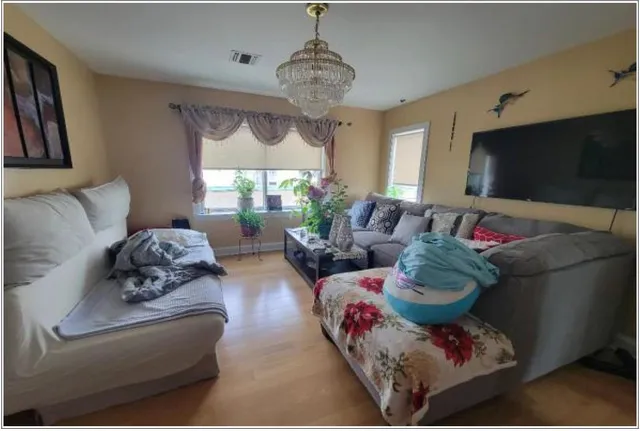 a living room with furniture and a flat screen tv
