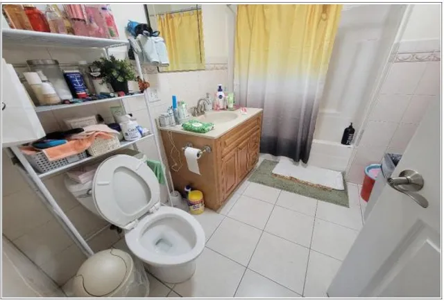 a bathroom with a sink mirror and toilet