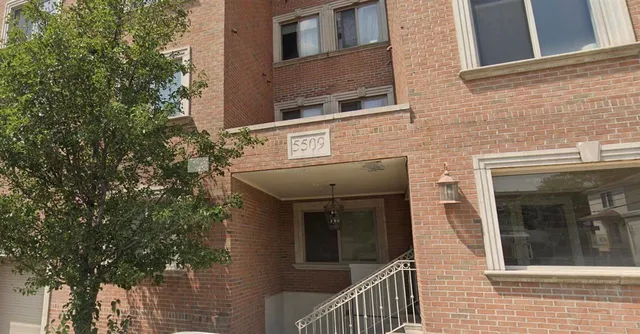 a view of a brick house with many windows