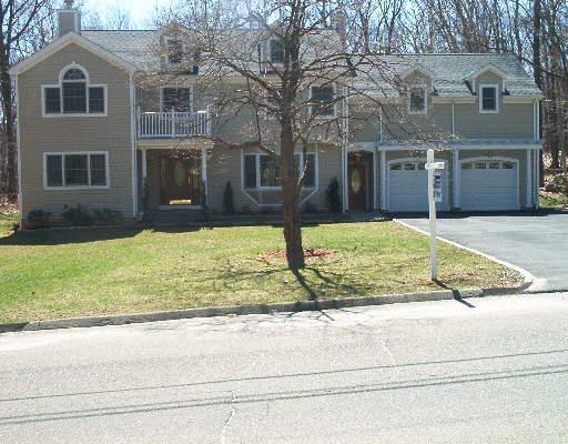 a view of a house with a yard and sitting area