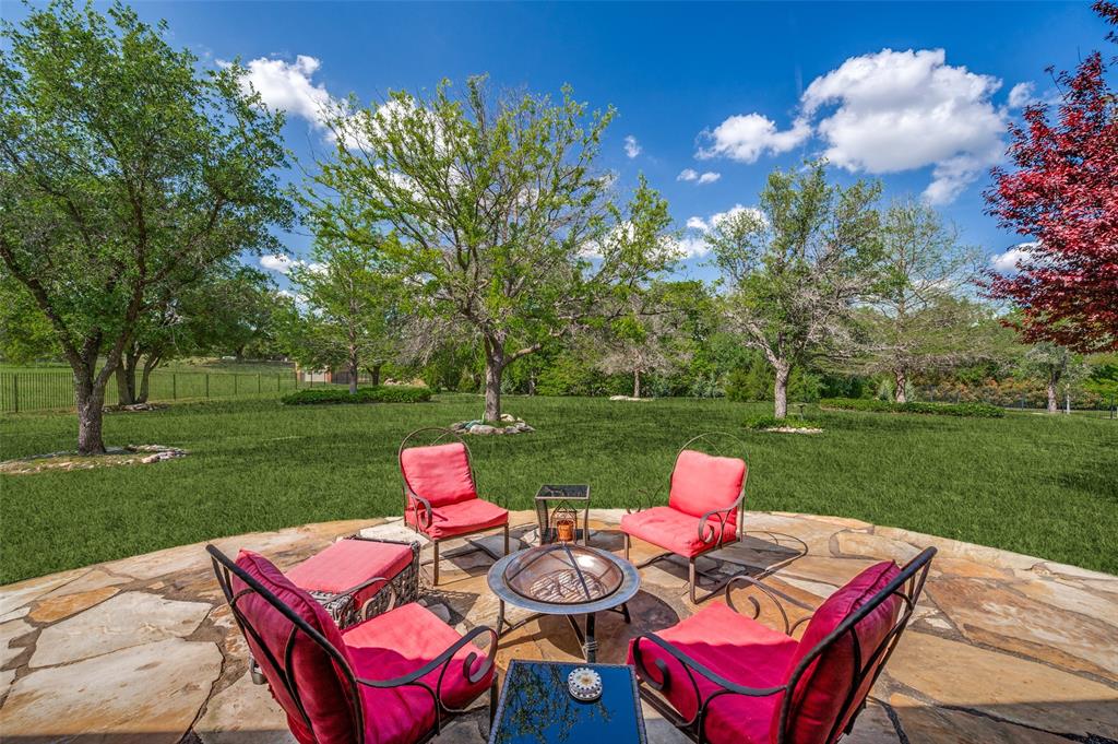 2841 Winding Creek Road Prosper, TX 75078 - Photo 33 of 40 a view of a table and chairs in back yard