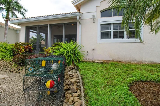 a view of an house with backyard and sitting area