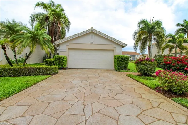a front view of house with yard and trees